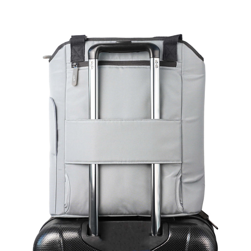 The Totepack's trolley sleeve over a rolling suitcase handle